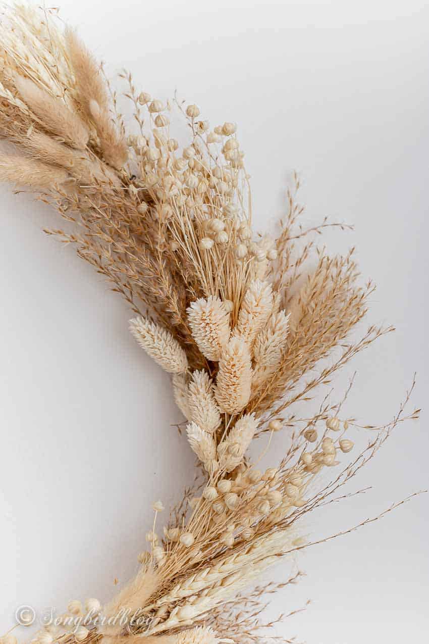 Partial image of a wheat and grass fall wreath.