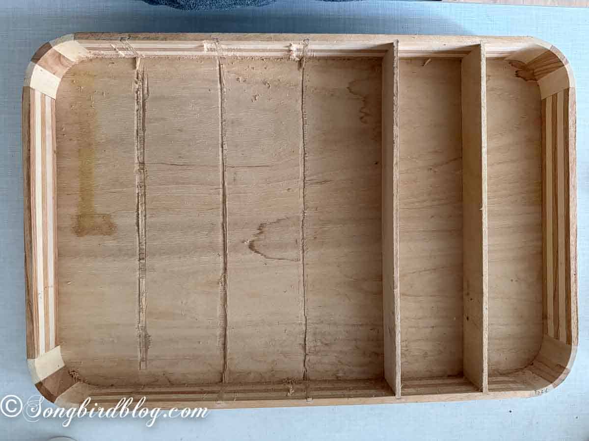 Partly dismantled wooden drawer insert, in the process of being made into rubber stamp storage.