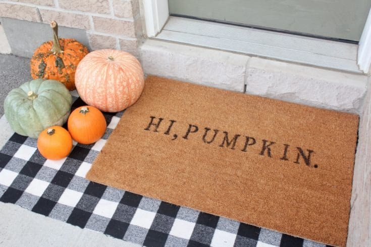 Brown doormat with stenciled text hi pumpkin.