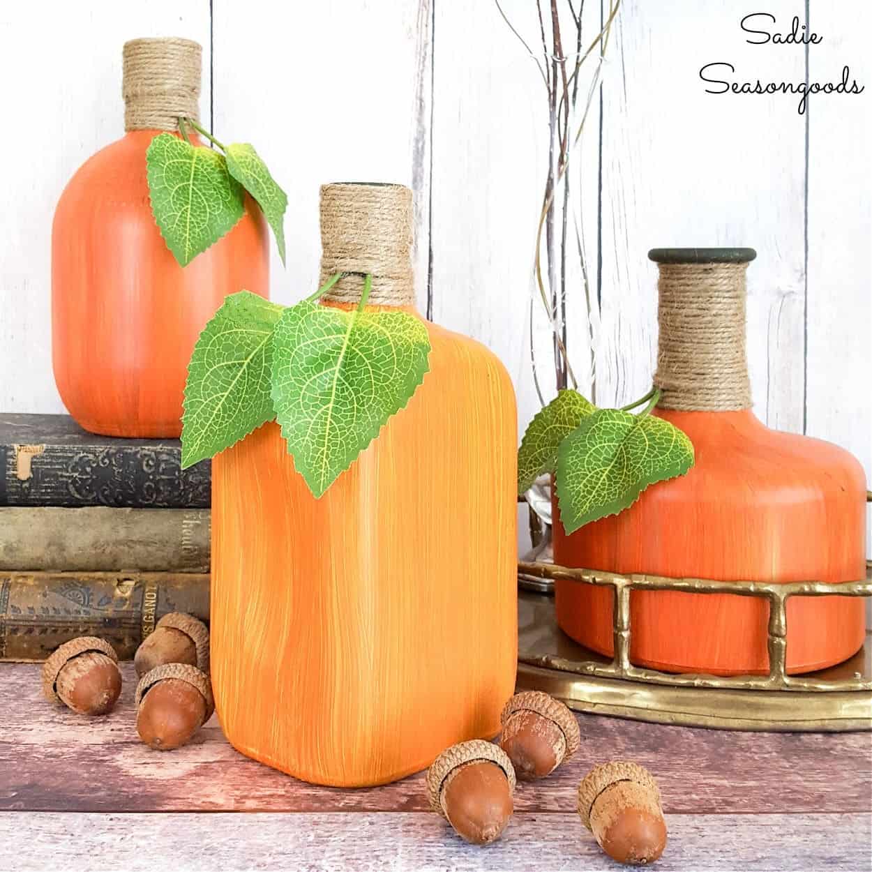three liquor bottles painted to look like gourds.