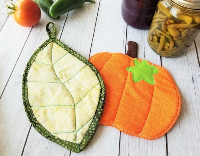 Homemade kitchen potholders in pumpkin and leaf design, fall craft.