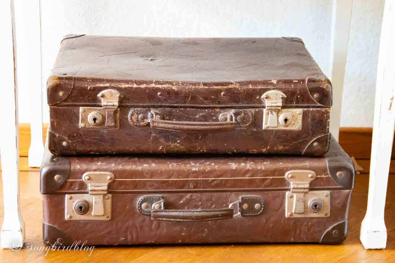Two stacked brown vintage suitcases.
