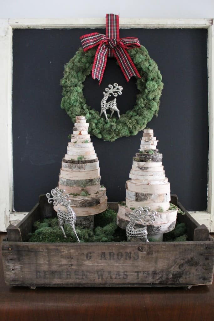 Two decorative wood Christmas trees made from stacked wood slices.