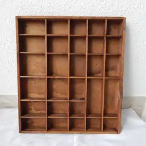 Brown wooden printer's tray with visible water damage.