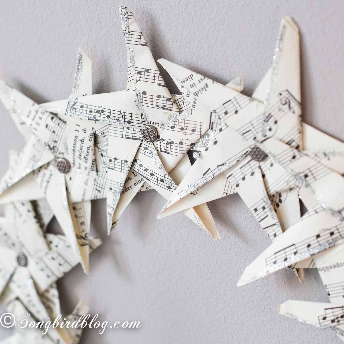 Closeup of a paper star wreath with glitter on the edges.