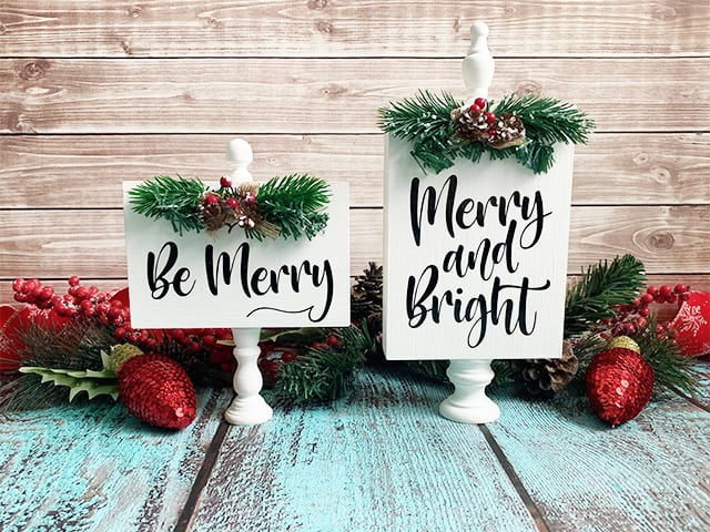 Two finials with mini signs Merry Christmas.