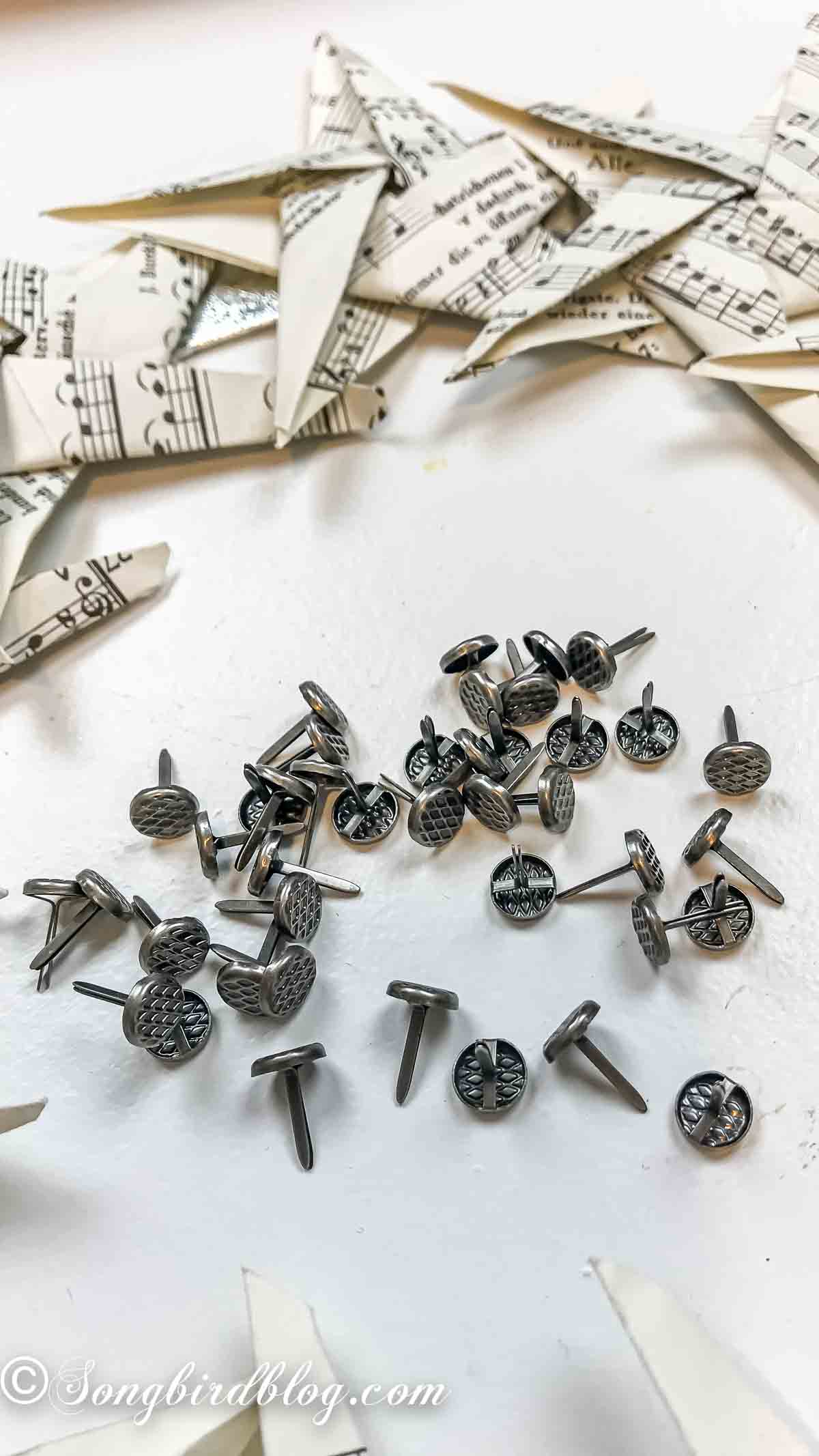 Split pins in the center of a DIY paper star wreath.