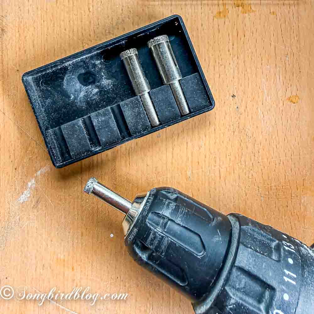 A hand drill with a diamond drill bit attached.