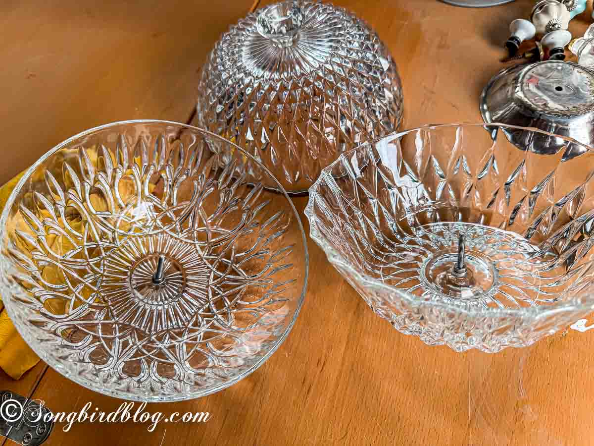 Crystal bowls showing a mounting screw from a drawer knob sticking up in the middle.