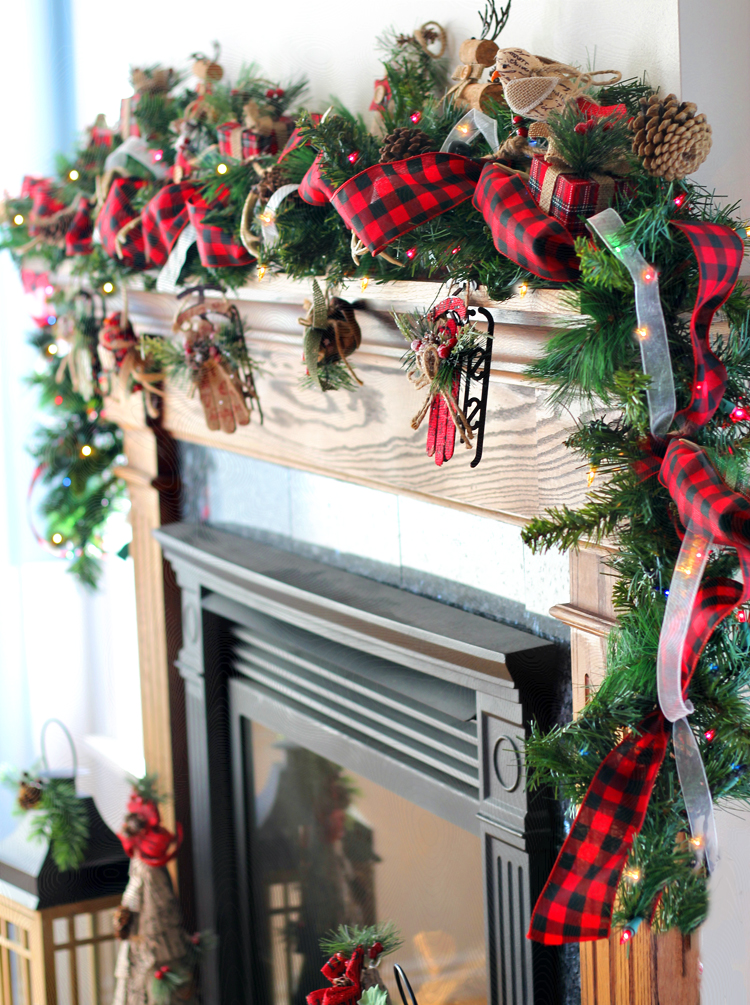 Green Christmas garland on mantel with gingham ribbon.