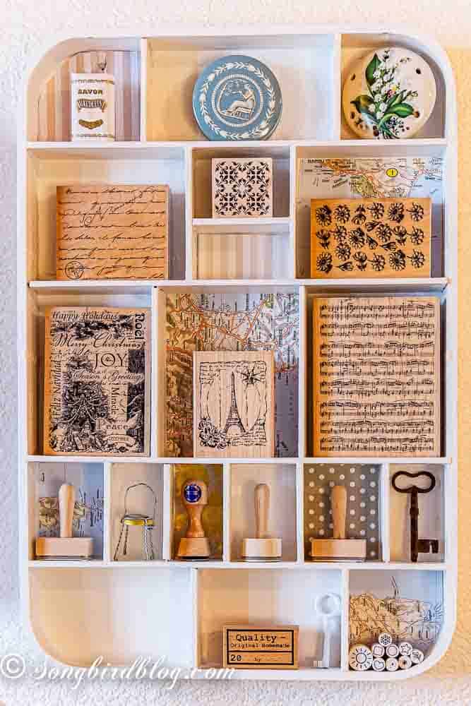 Wooden stamp organisation solution showing stamps sorted by size in tray compartments.