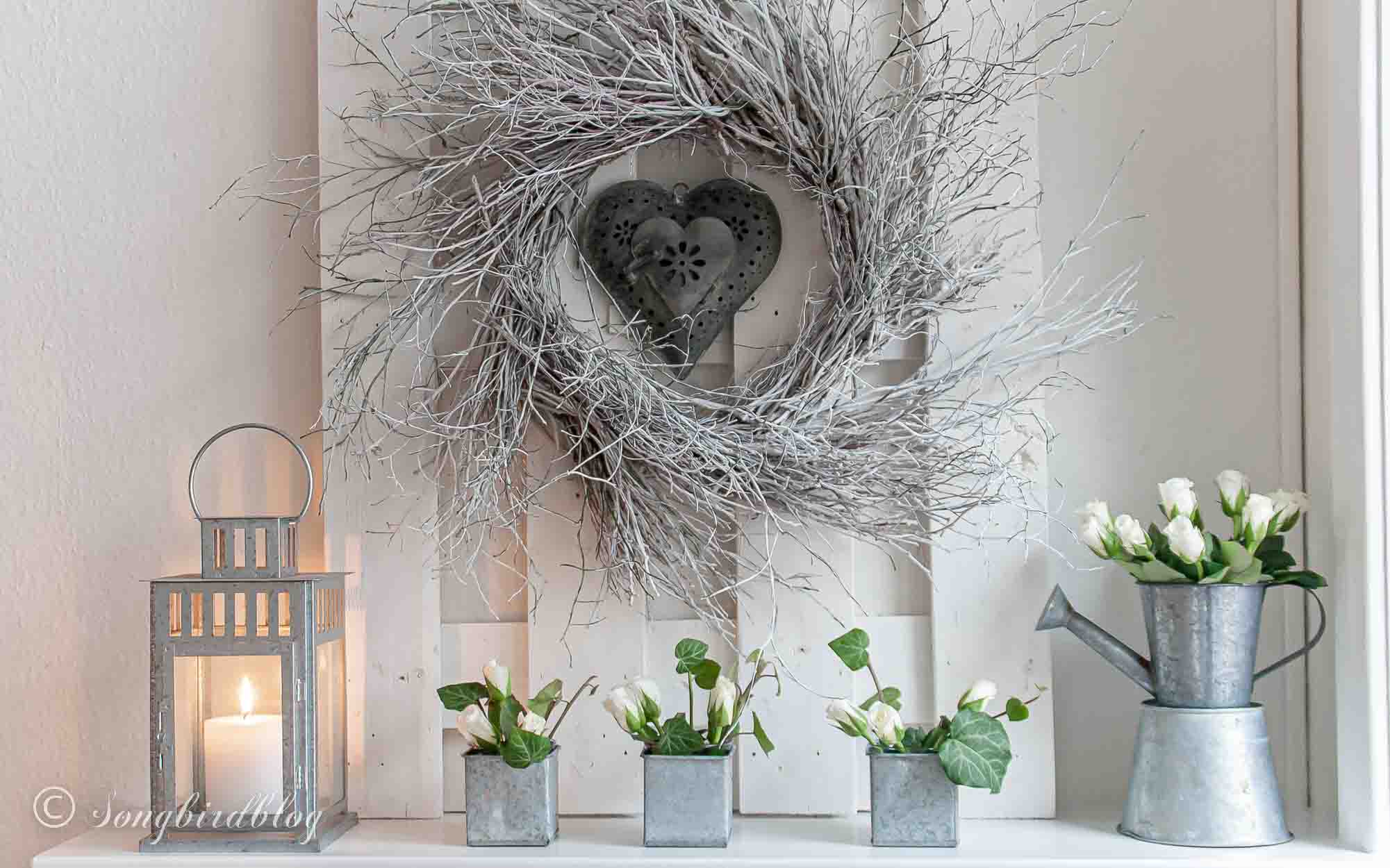 Rustic Valentine'd Day mantel with a white twig heart and a rustic metal heart.