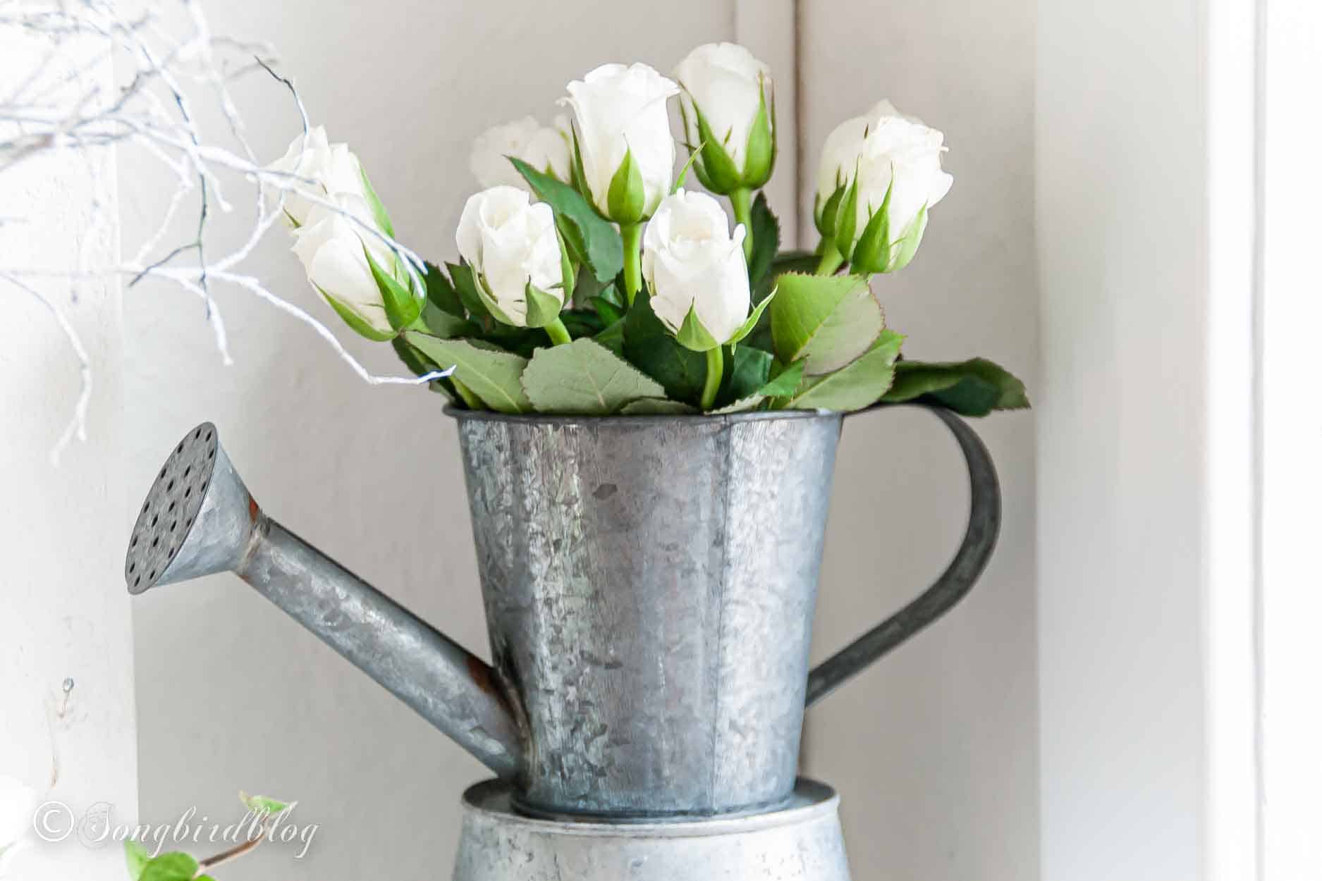 Rustic Valentine'd Day mantel with a white twig heart and a rustic metal heart.