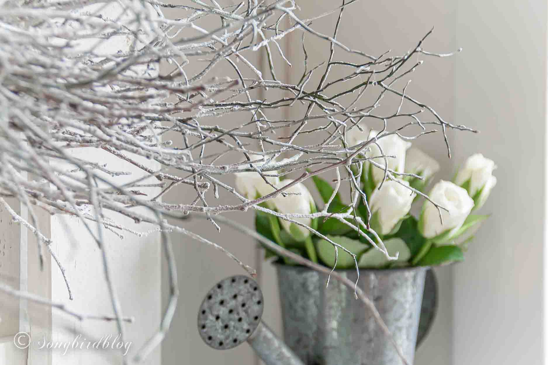 Rustic Valentine'd Day mantel with a white twig heart and a rustic metal heart.