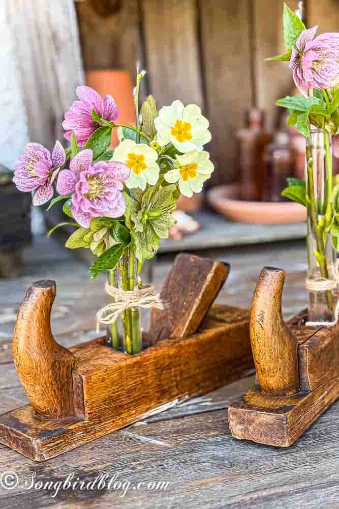 Two vintage wooden planers decorated with flowers.