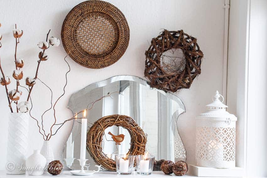Mirror mantel decor in white and brown tones.
